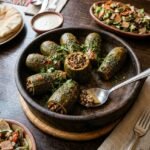 Tender zucchini stuffed with a savory blend of plant-based minced meat and earthy mushrooms, perfectly roasted for a rich, guilt-free flavor. كوسة غضة محشوة بمزيج شهي من اللحم النباتي المفروم والمشروم، محمرة بعناية لتقدم طعماً غنياً وخياراً صحياً مثالياً.